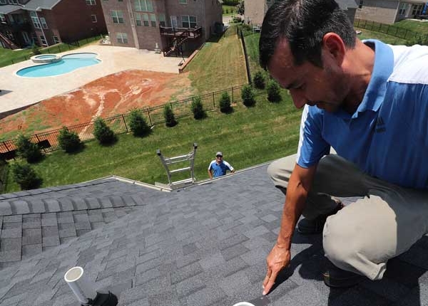 Knoxville Engineered Home Inspections Bert on Roof pointing out defect